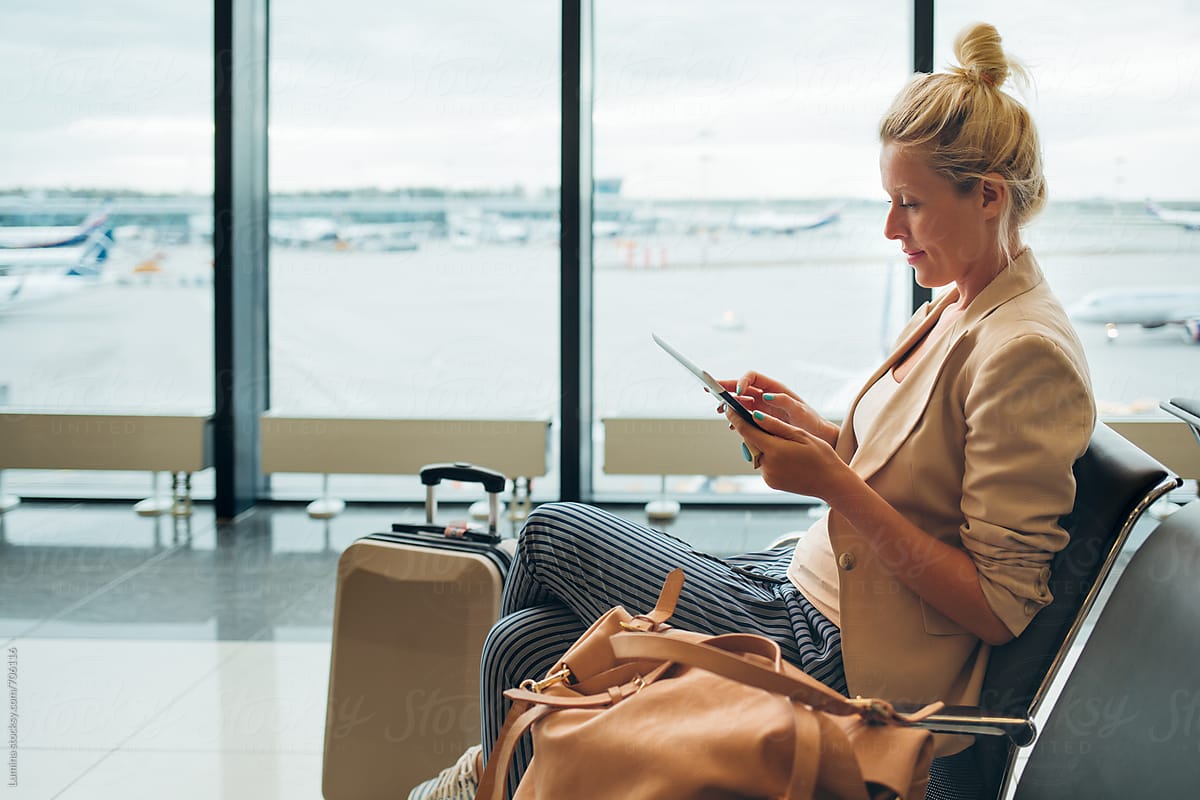 Woman With a Tablet at  an Airport Departure Lounge