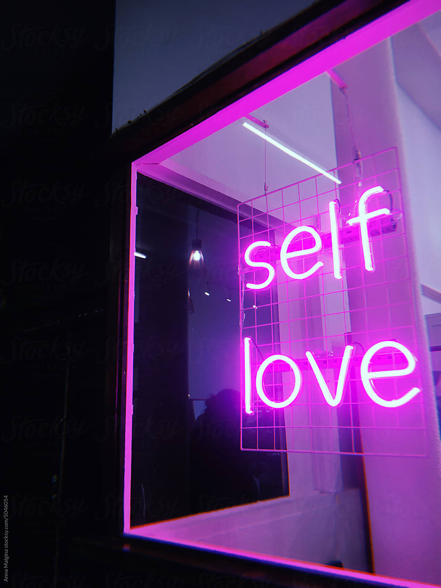 A neon sign self love at night