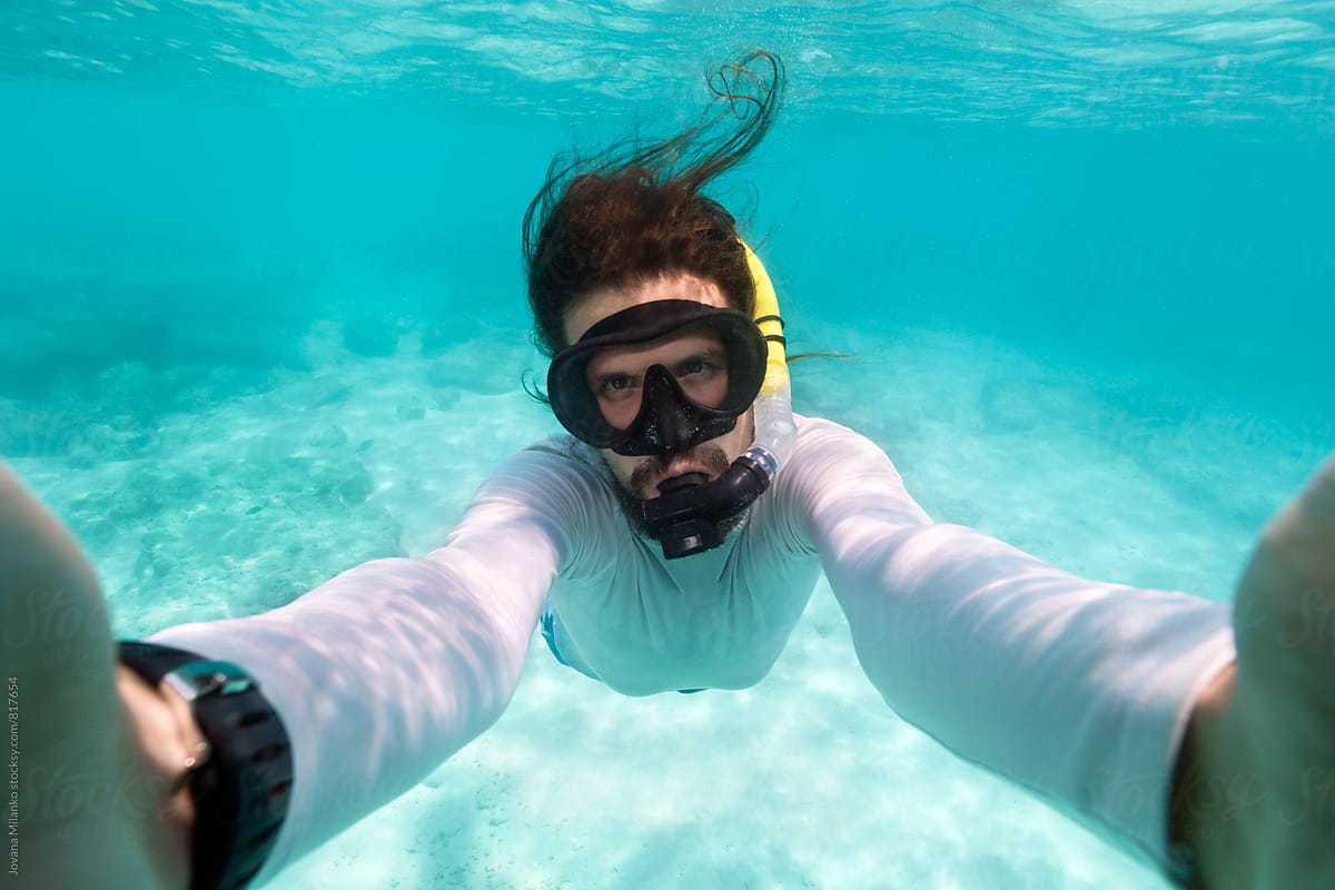 Man Making Snorkeling Selfie in Turquoise Tropical Sea