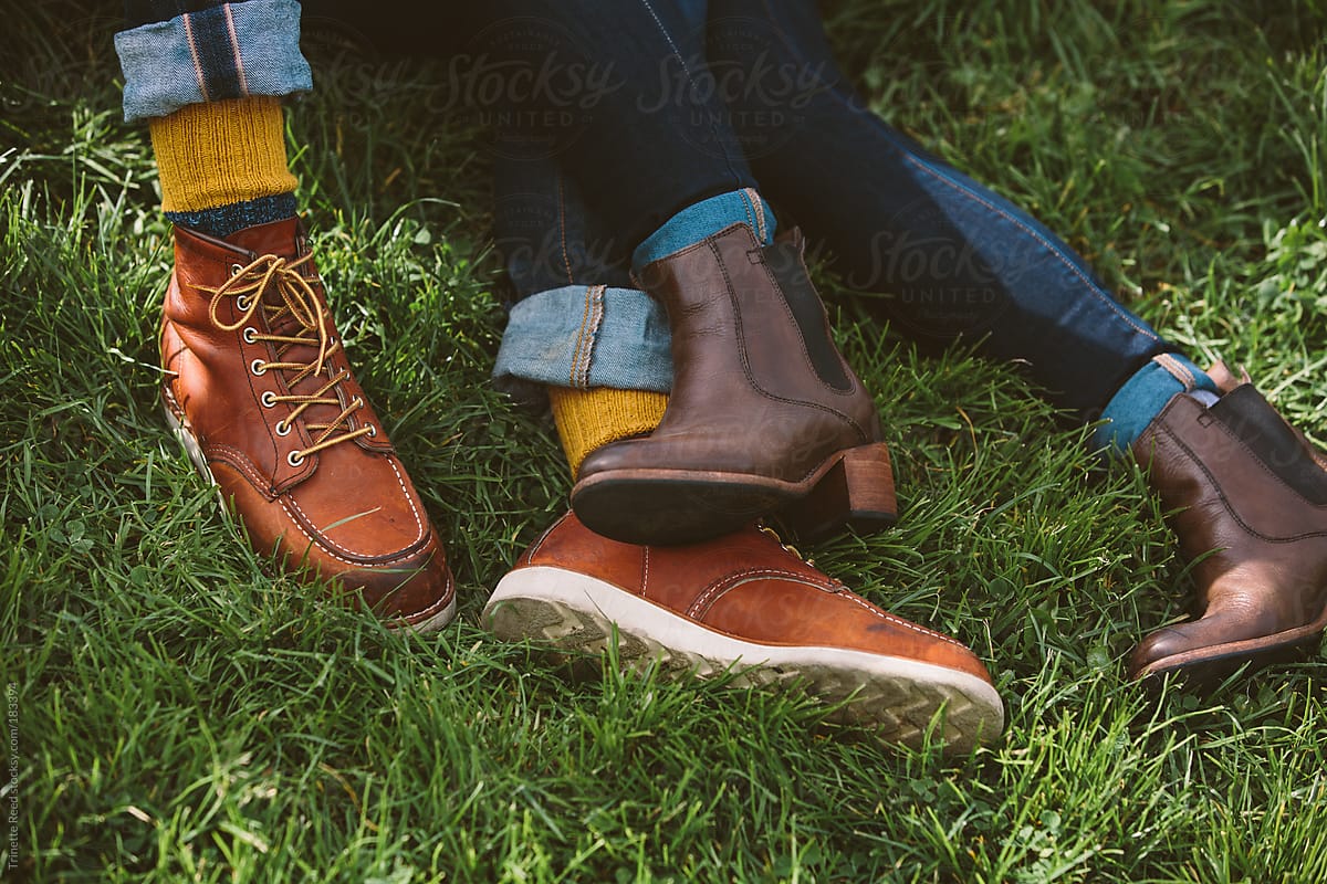 Detail of couples feet in grass