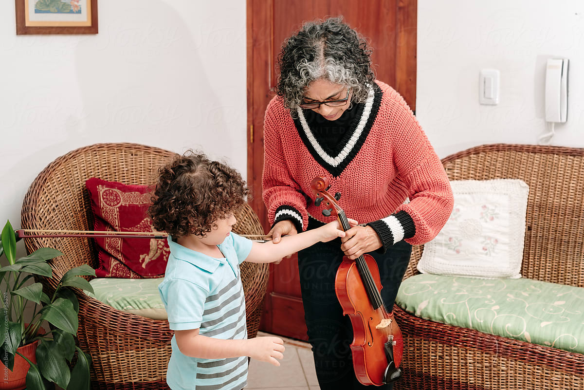 Teacher handing a musical instrument to a student
