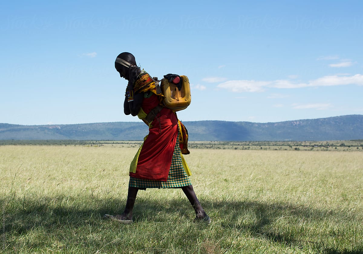 Maasai woman carrying water. Kenya. Africa.