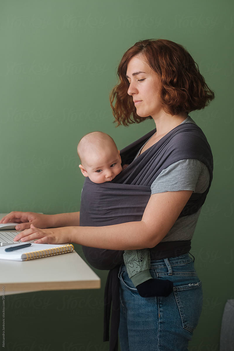 Woman With Baby Working In The Home Office