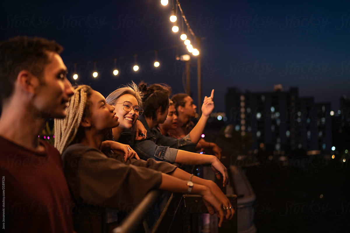 Multi-Ethnic Group of friends looking at city at night