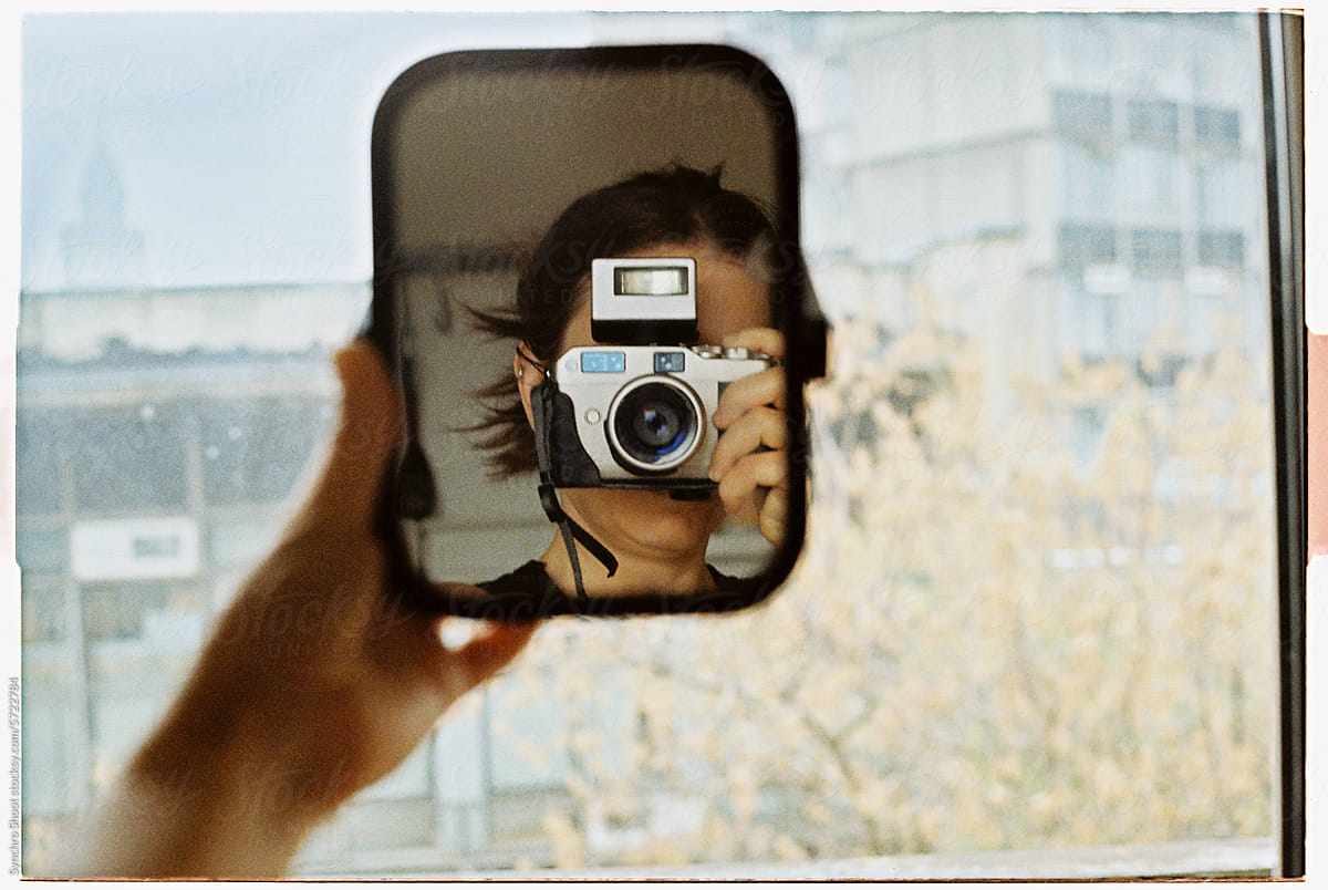 Self-portrait with mirror and film camera