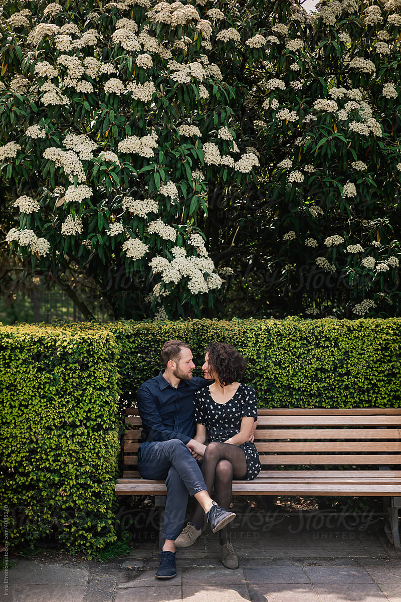 Couple talking on park bench