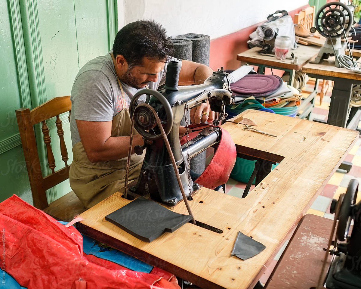 Latino man using a sewing machine