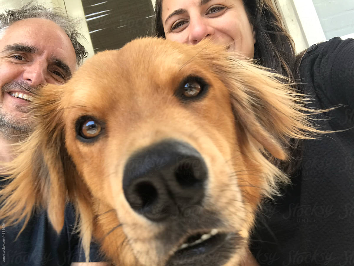 Selfie with dog photobomb by Juno for Stocksy United