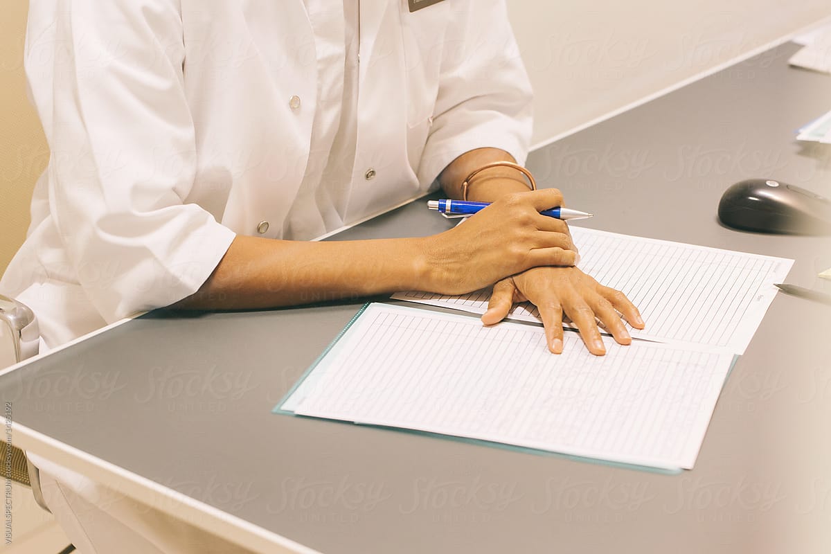 Female Doctor Taking Notes on Paper