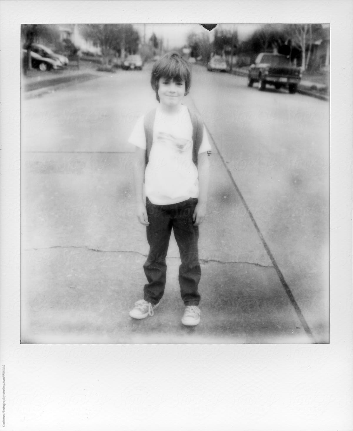 Seven year old boy stands in the middle of the street