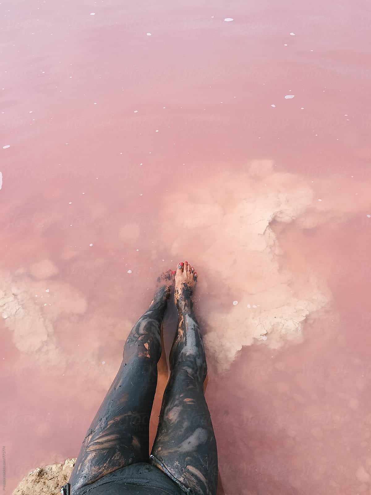 Bathing in pink salty lake of Torrevieja, Alicante, Spain