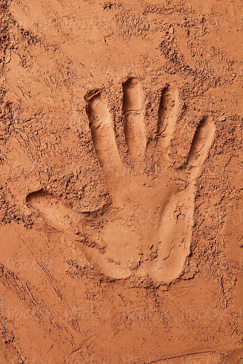 Handprint on cocoa powder background.
