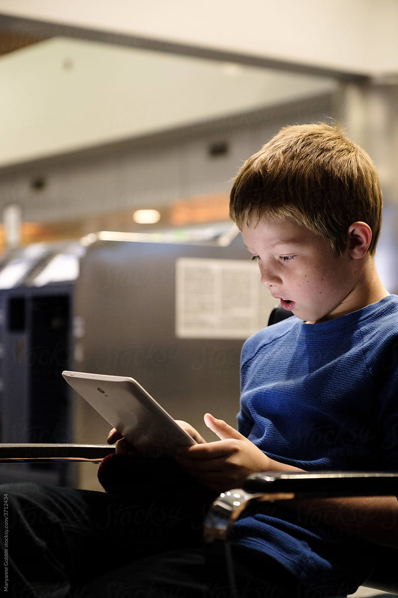 Child Looking at Screen in Airport