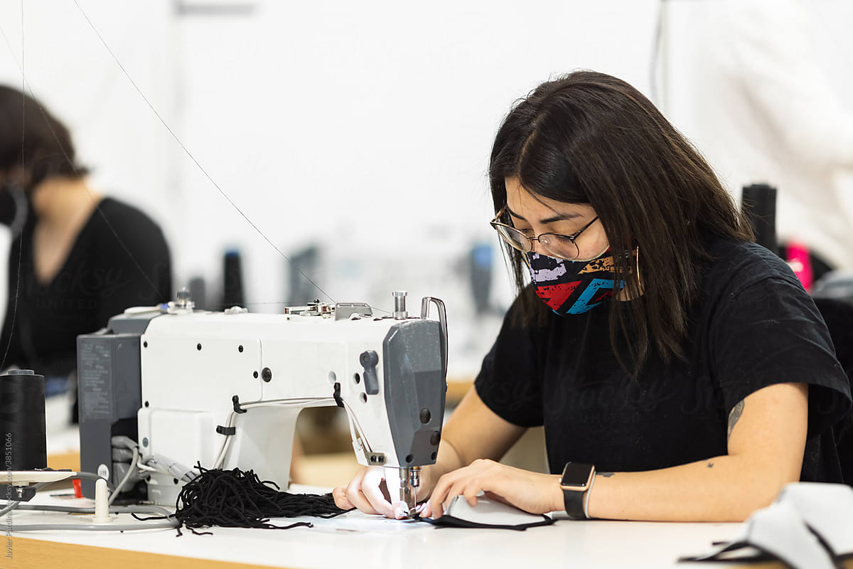 Young woman working with sewing machine