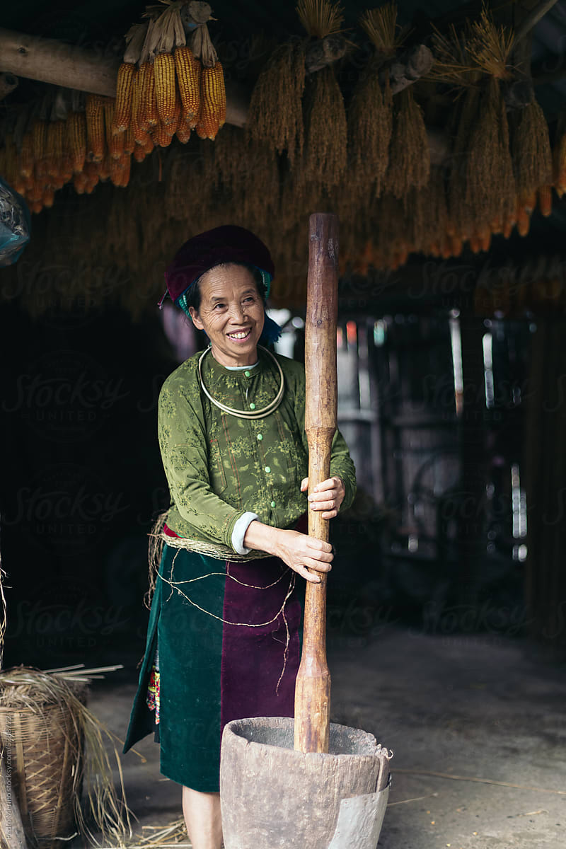 Cheerful Vietnamese local woman working with hemp in her workshop