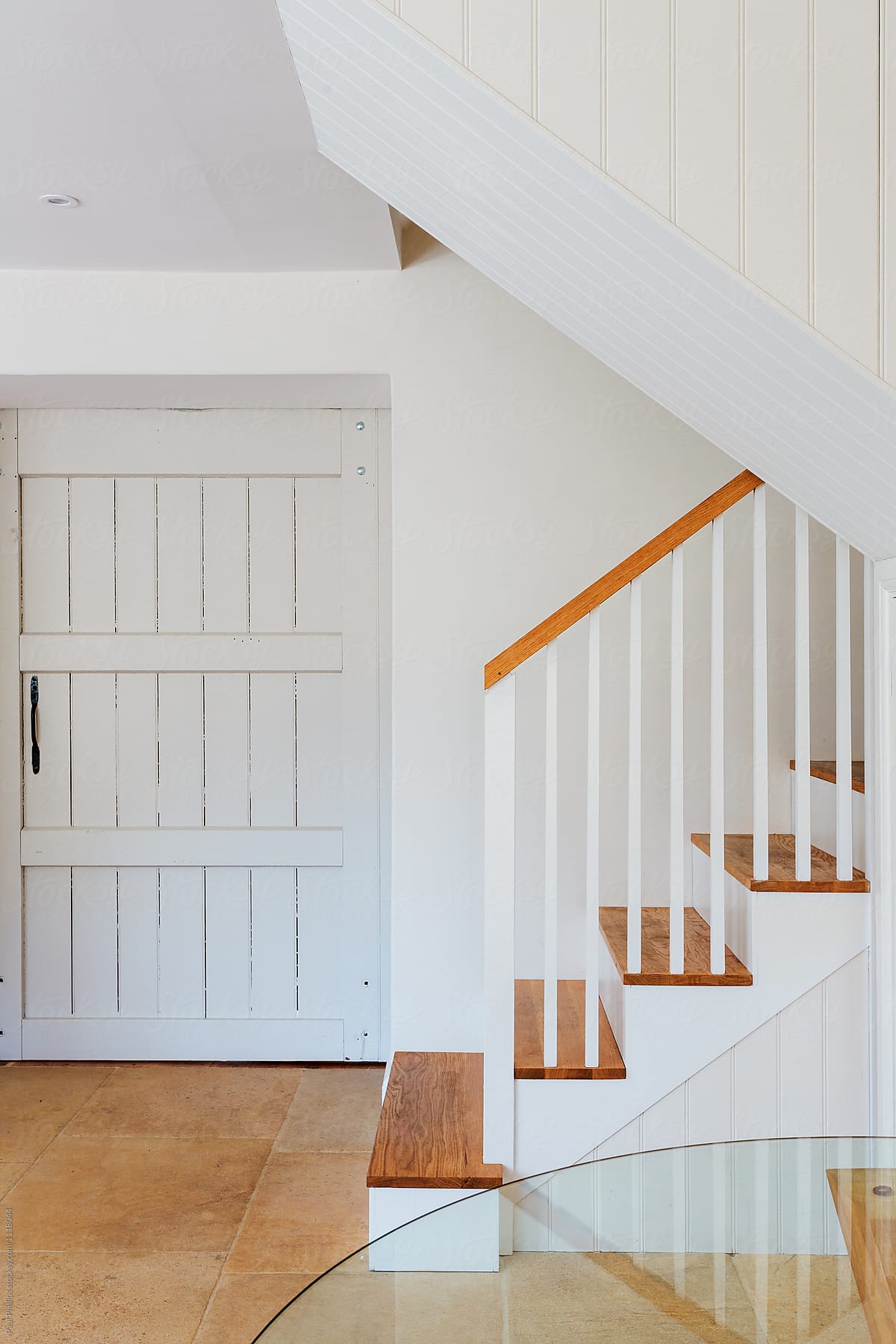 Modern white staircase in a converted barn.
