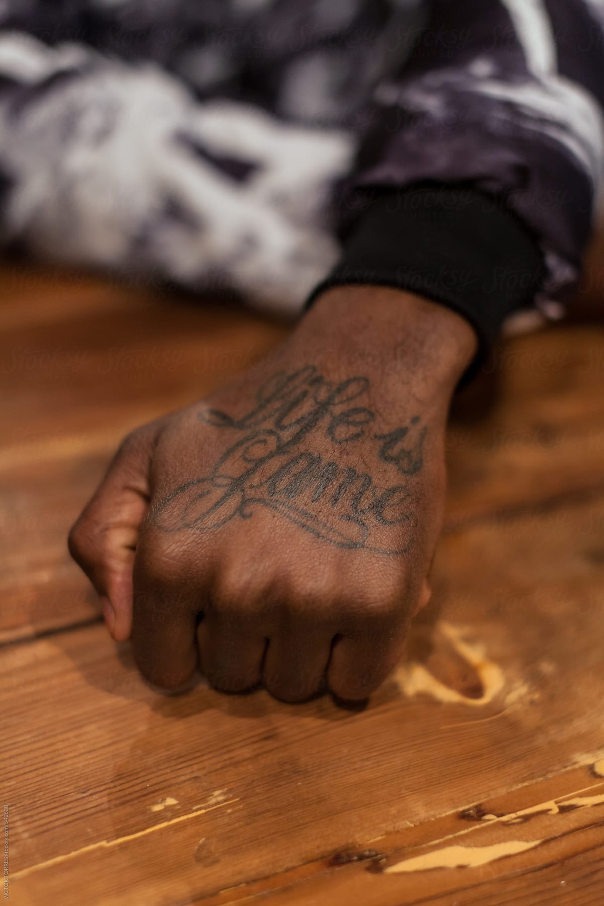 Hand Of An African Man With A Letter Tattoo