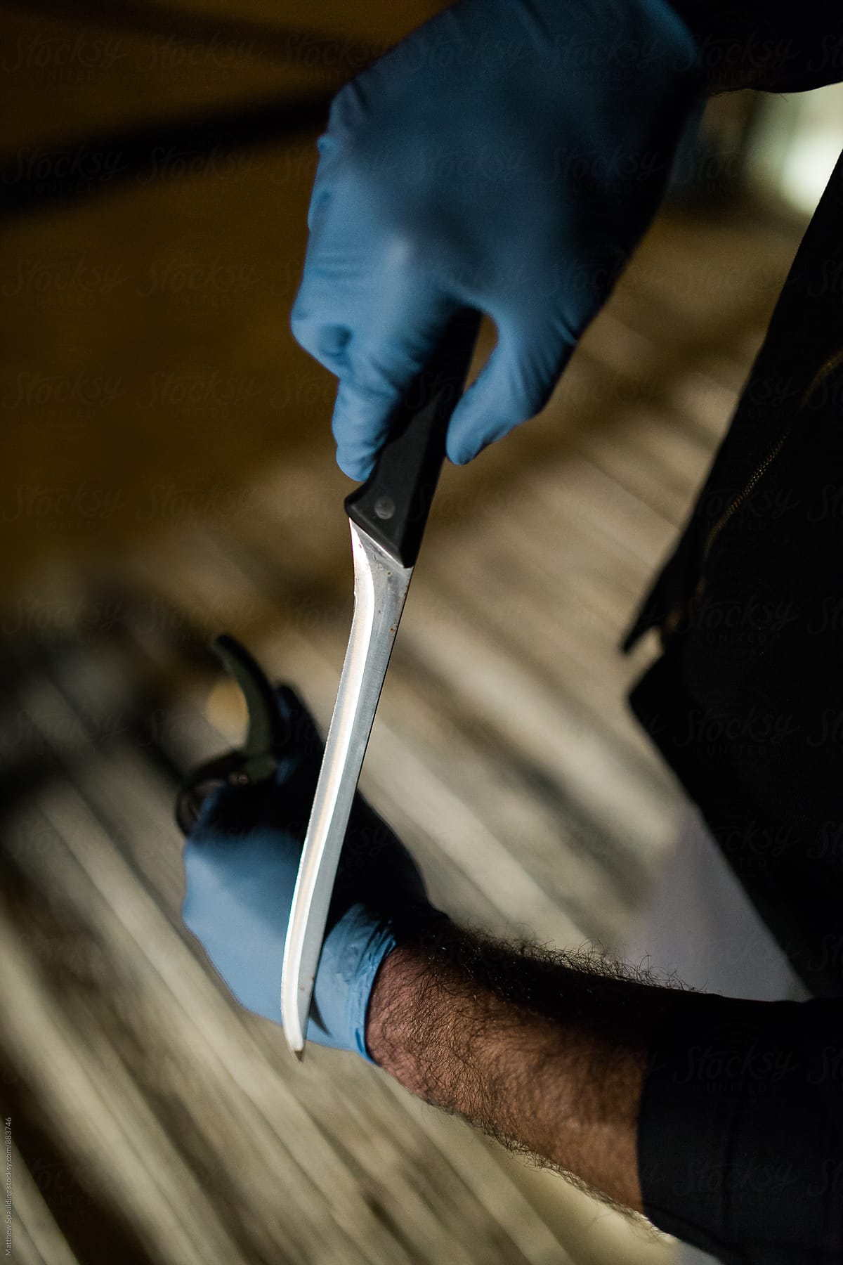 Sharp Fillet Knife In Hands Of Man Wearing Rubber Gloves by Stocksy  Contributor Matthew Spaulding - Stocksy