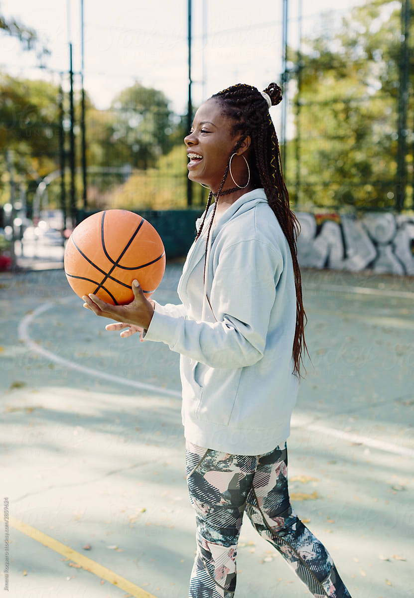 Young black woman with basketball ball