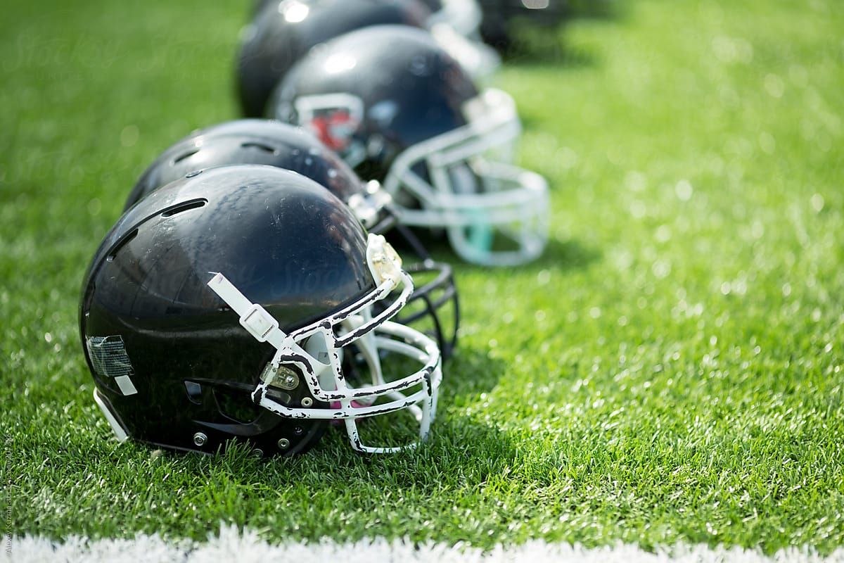 american football helmets on the green grass