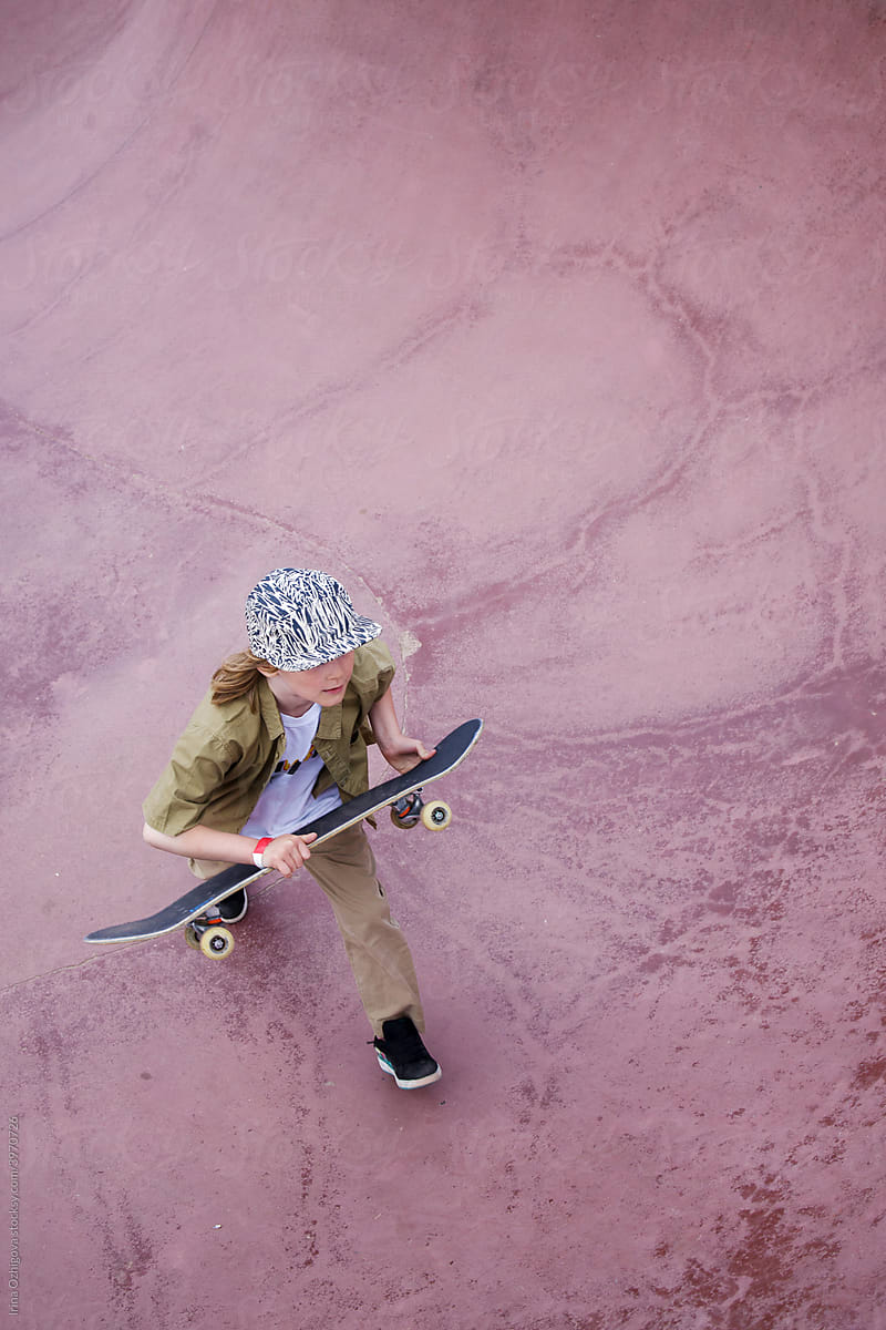 Little skateboarder  running out of  a skate  bowl