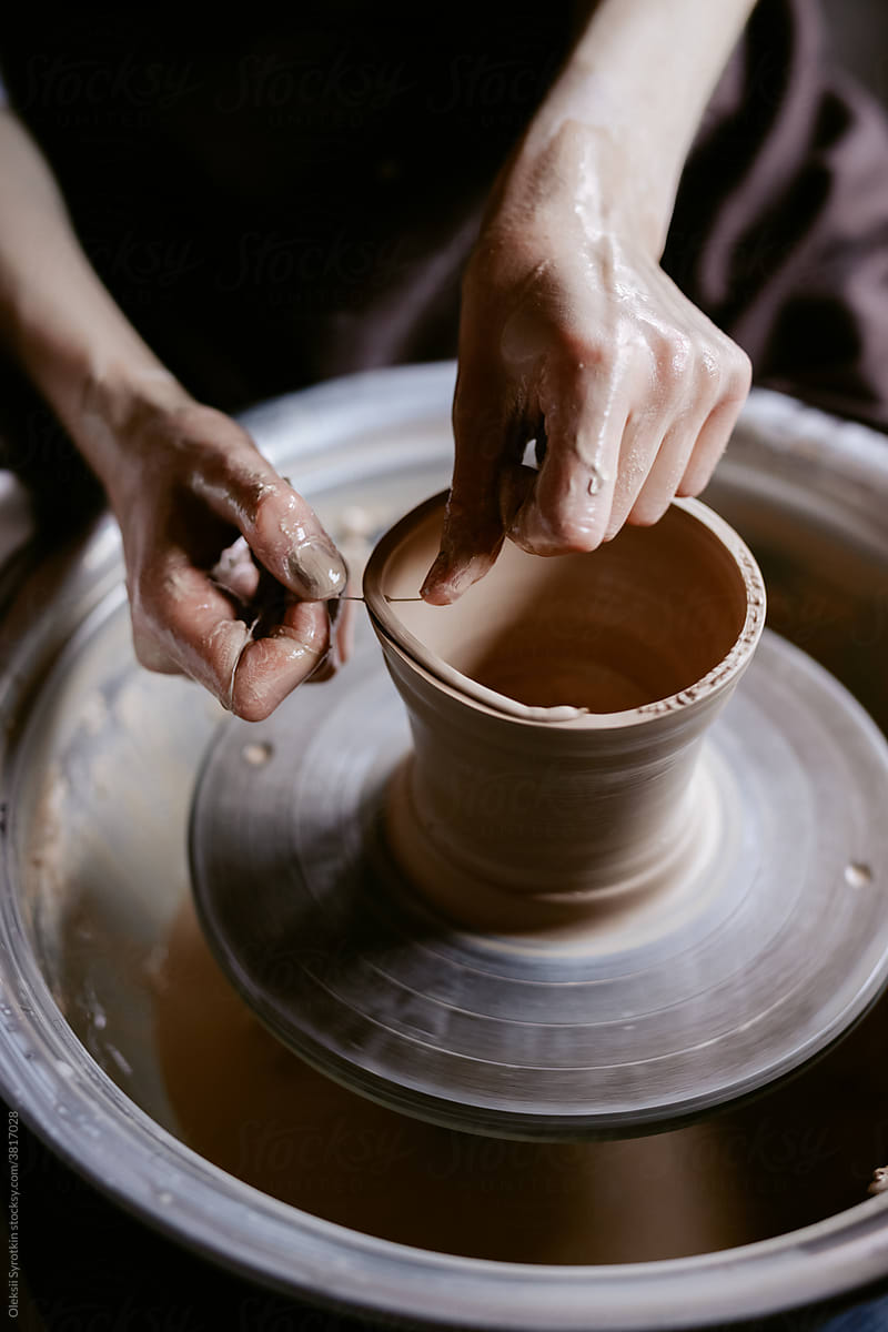 Sculptor smoothing edge of bowl