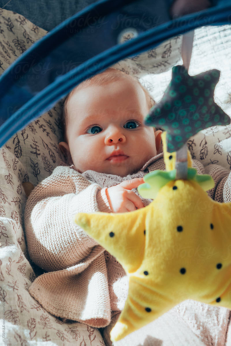 Chubby baby with crib toys