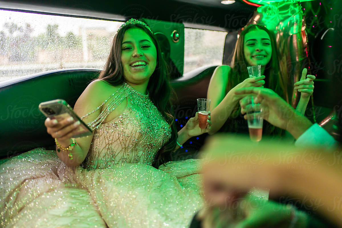 Quinceanera With Friends On Her 15th Birthday Party In A Limousine.