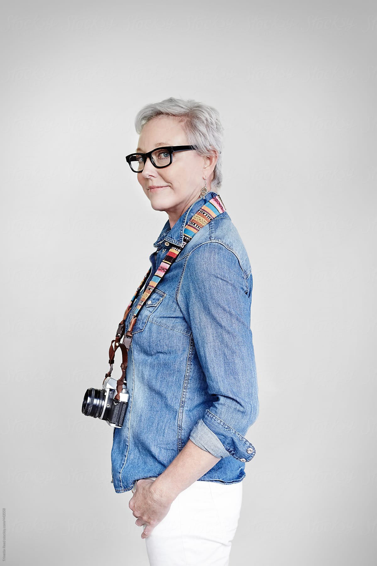 Portrait of stylish mature woman with vintage film camera