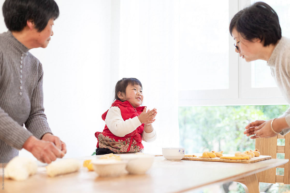 happy asian family making Chinese bread in home