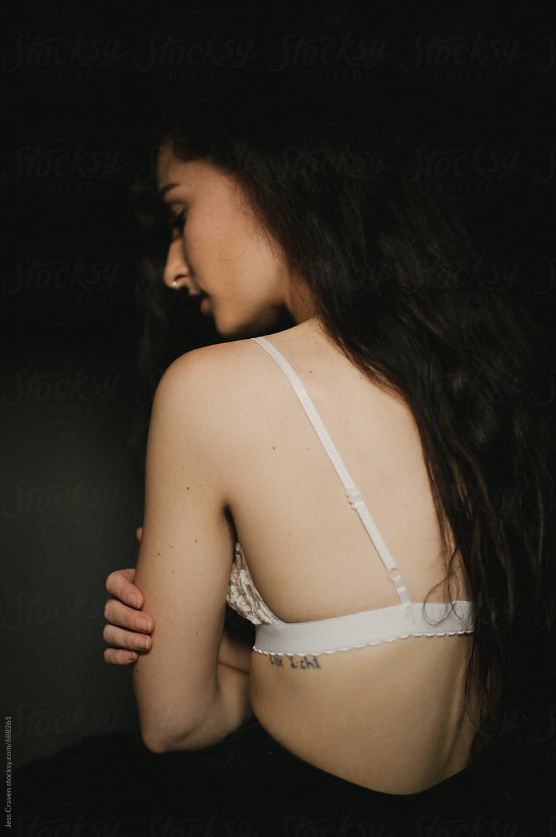 Skinny Girl Wearing White Bra With Boney Spine Showing by Stocksy