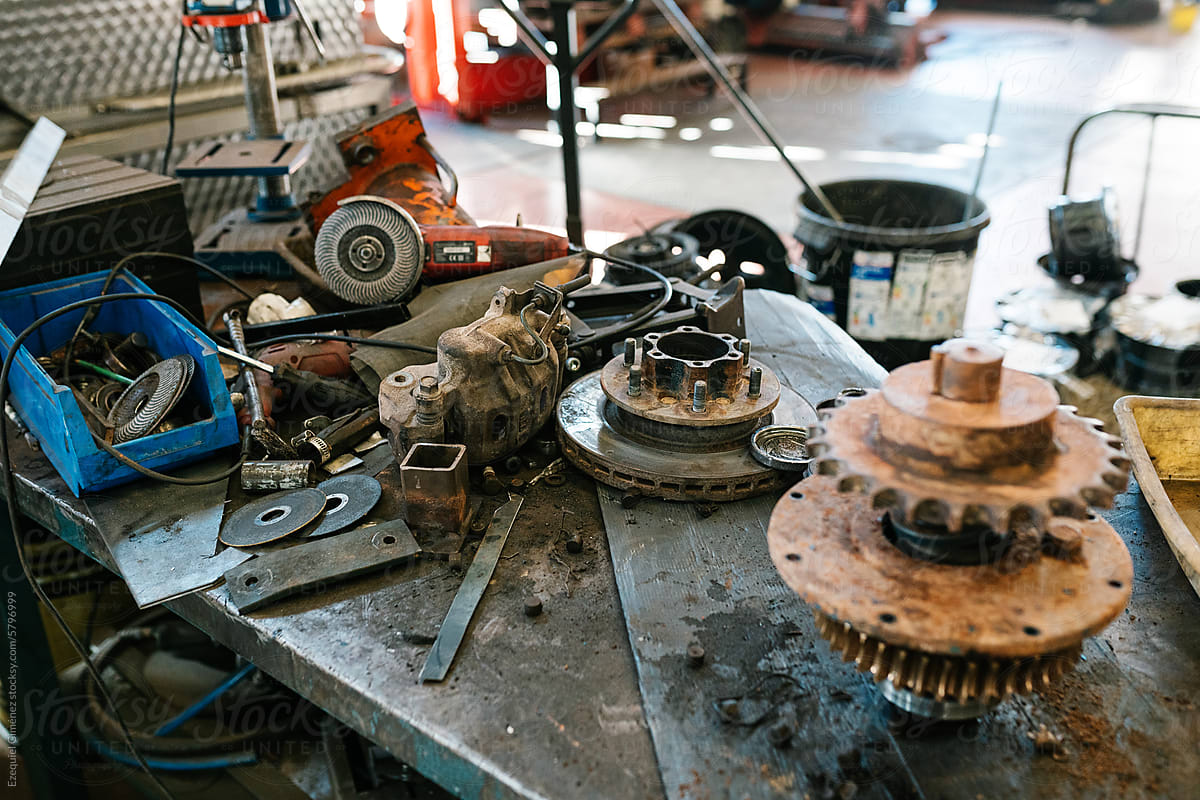 Old rusty metal gear engine of vehicle in garage at workshop