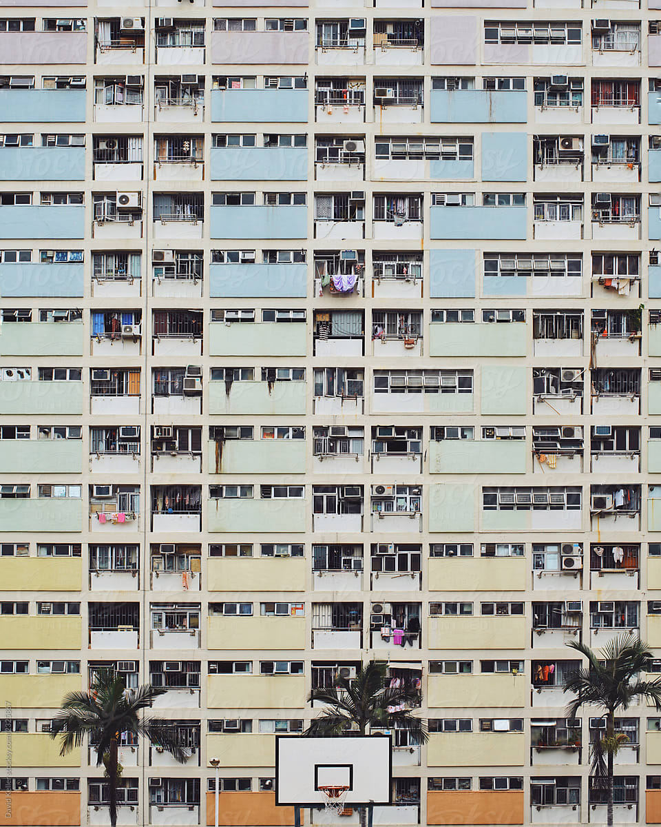 A colorful rainbow apartment building above a basketball court in rural Hong Kong