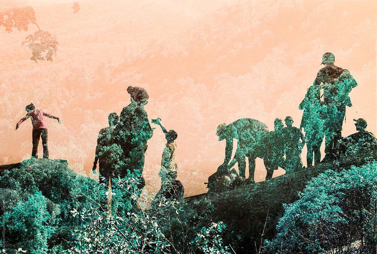 Double Exposure of group of people on summit of hike filled with green trees
