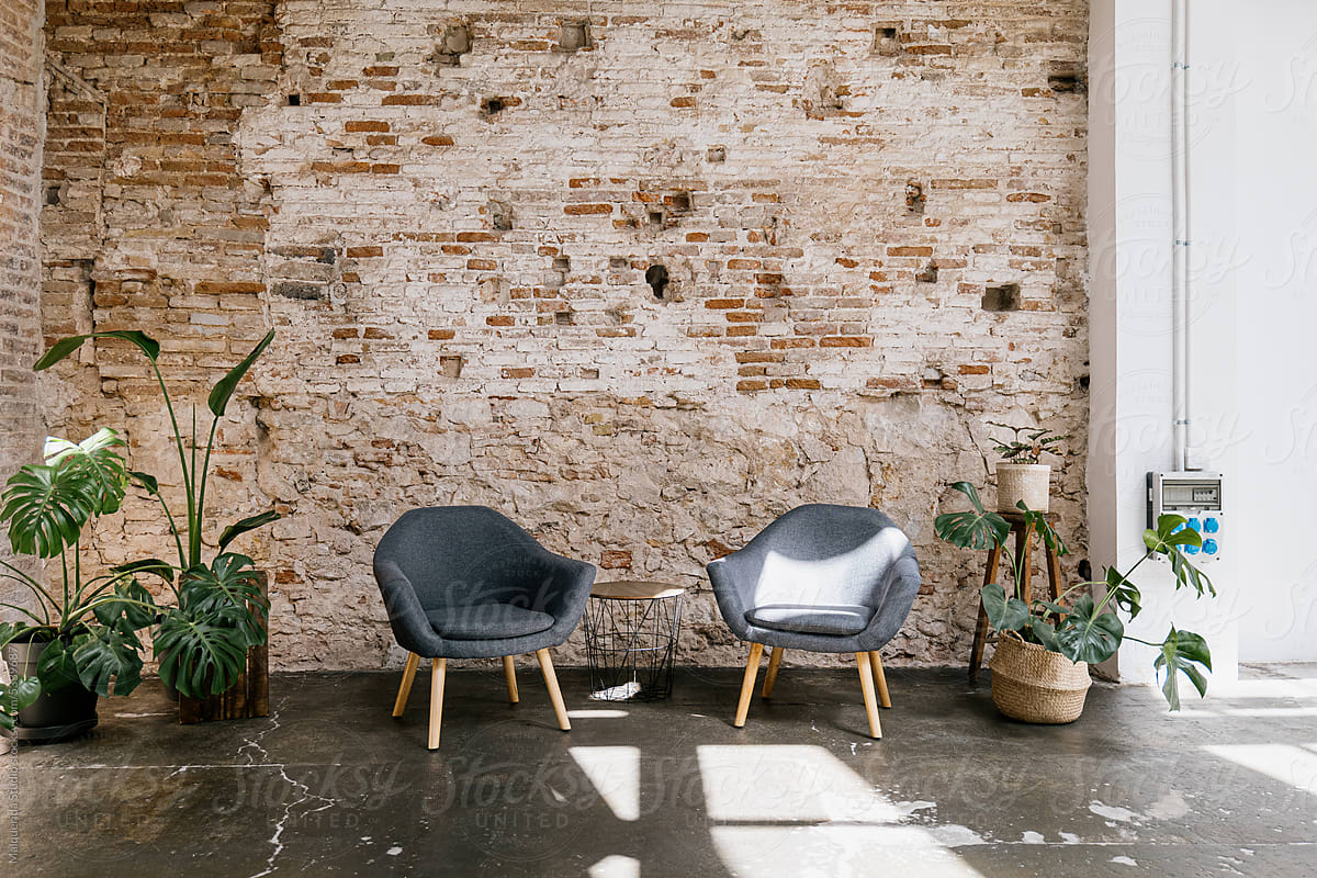 Armchairs and plants in a brick wall