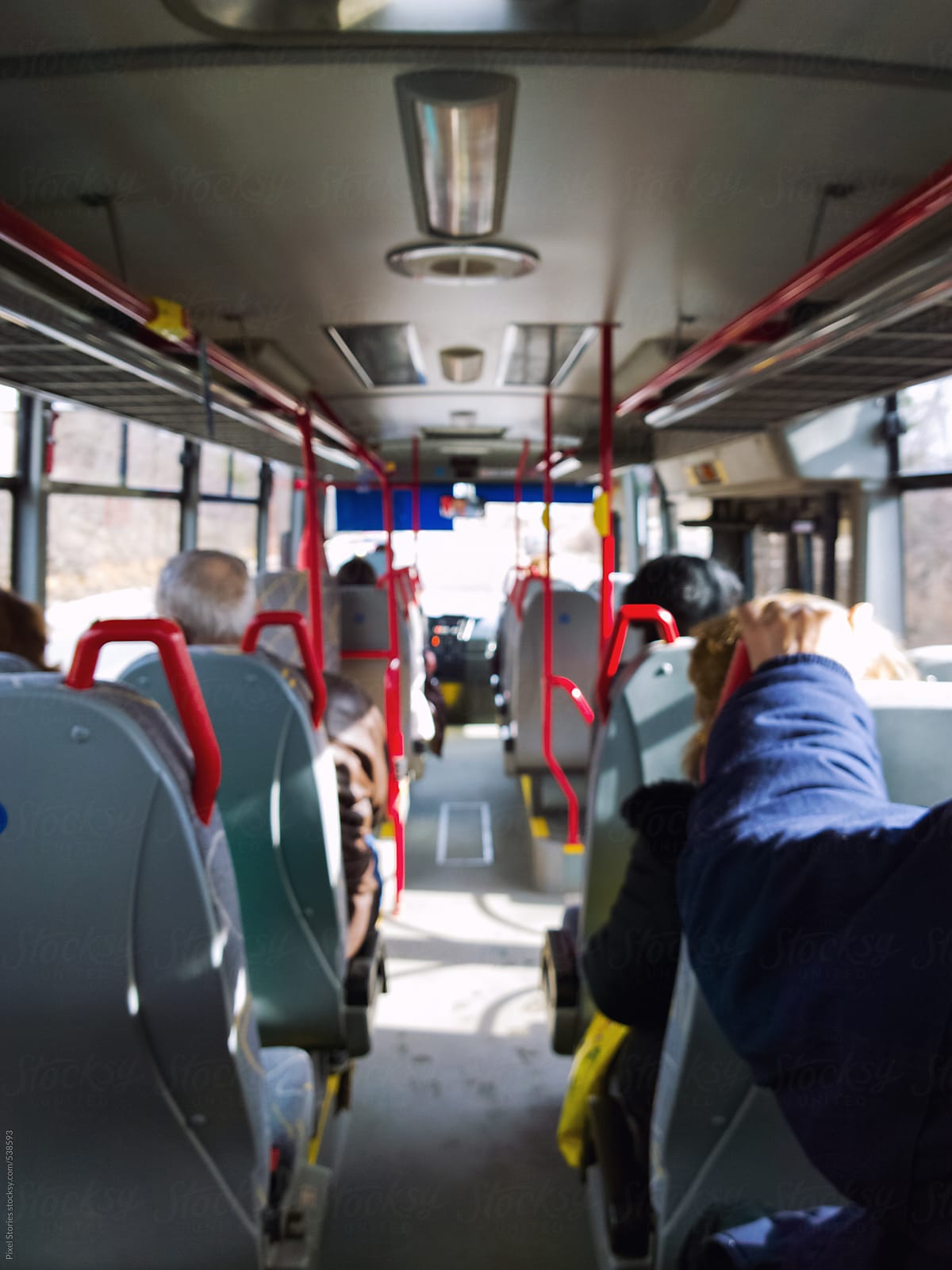 Unrecognizable commuters riding a bus