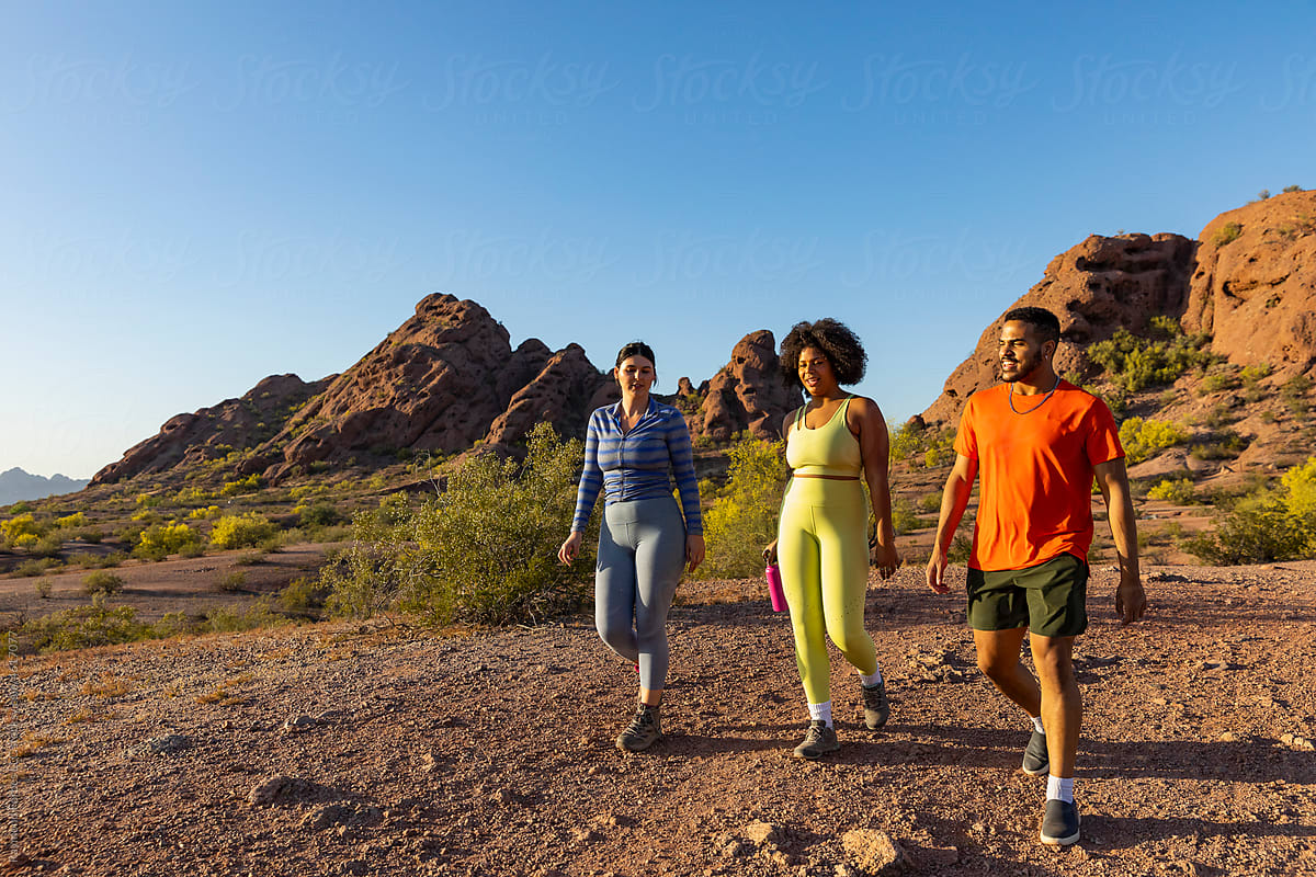 African  American walkers on trail in arizona with friends