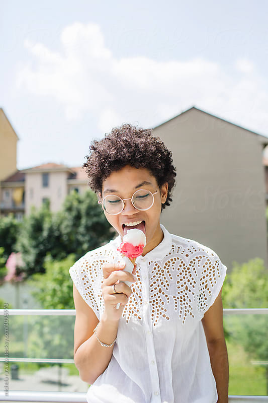 Woman licking an ice cream in a sunny day