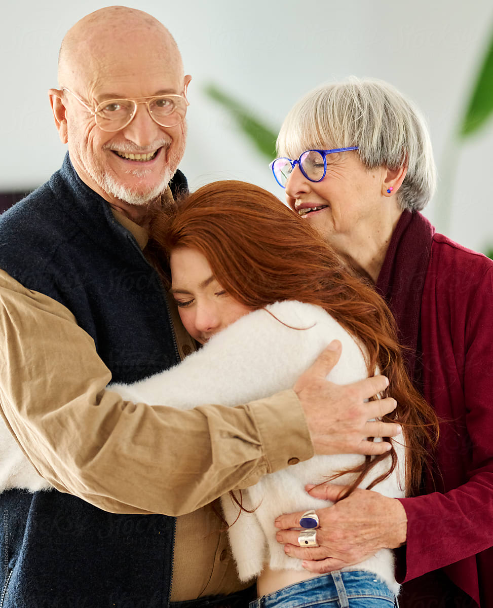 Granddaughter embracing grandfather and grandmother