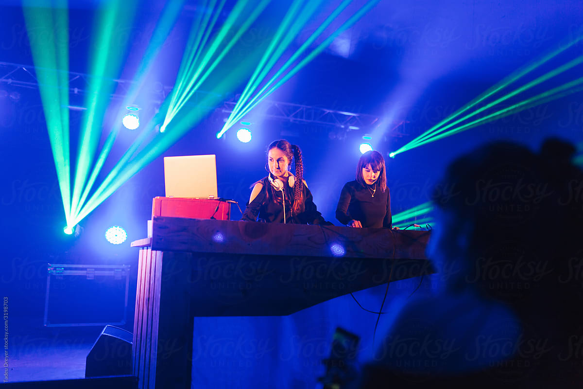 Young DJ women playing music at a party
