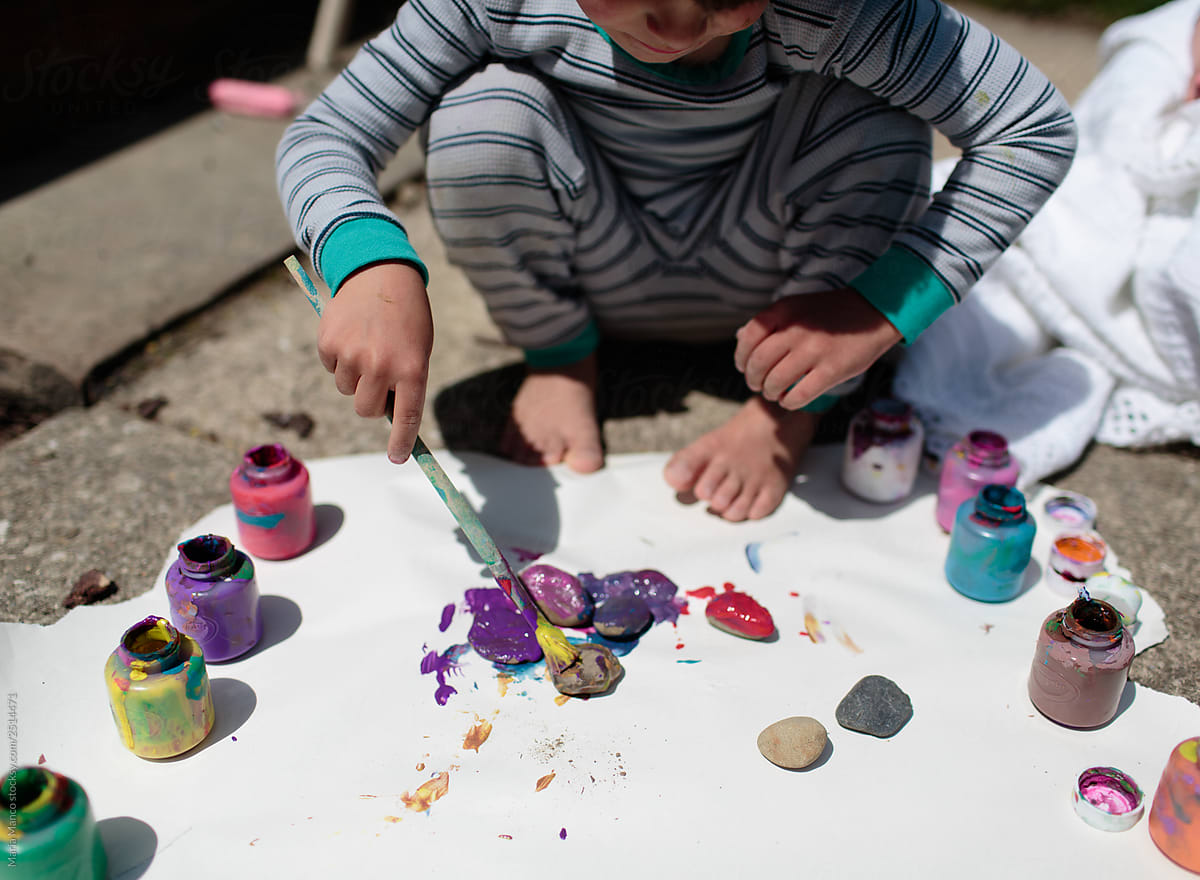child painting rocks