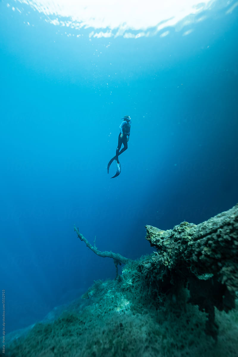 freediver in blue cenote