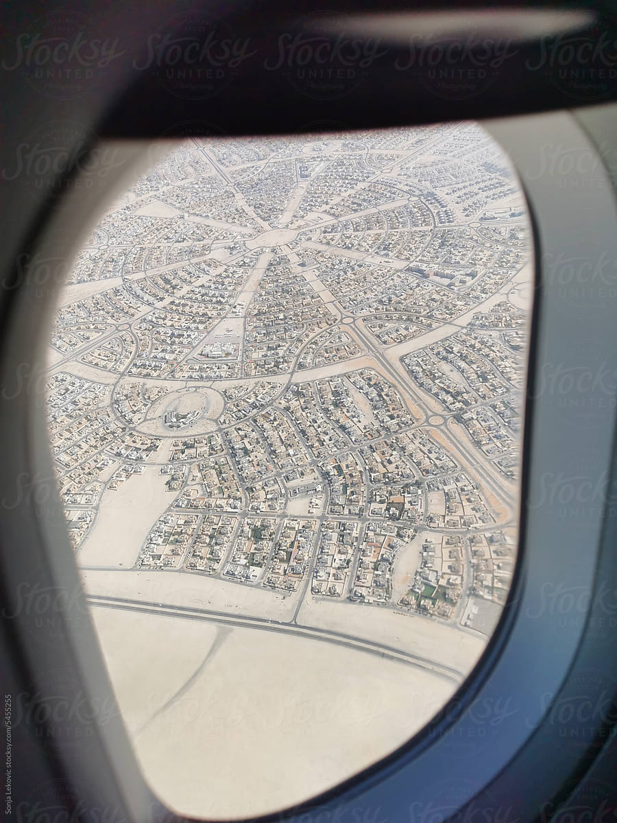 Airplane window view of Abu Dhabi city from above