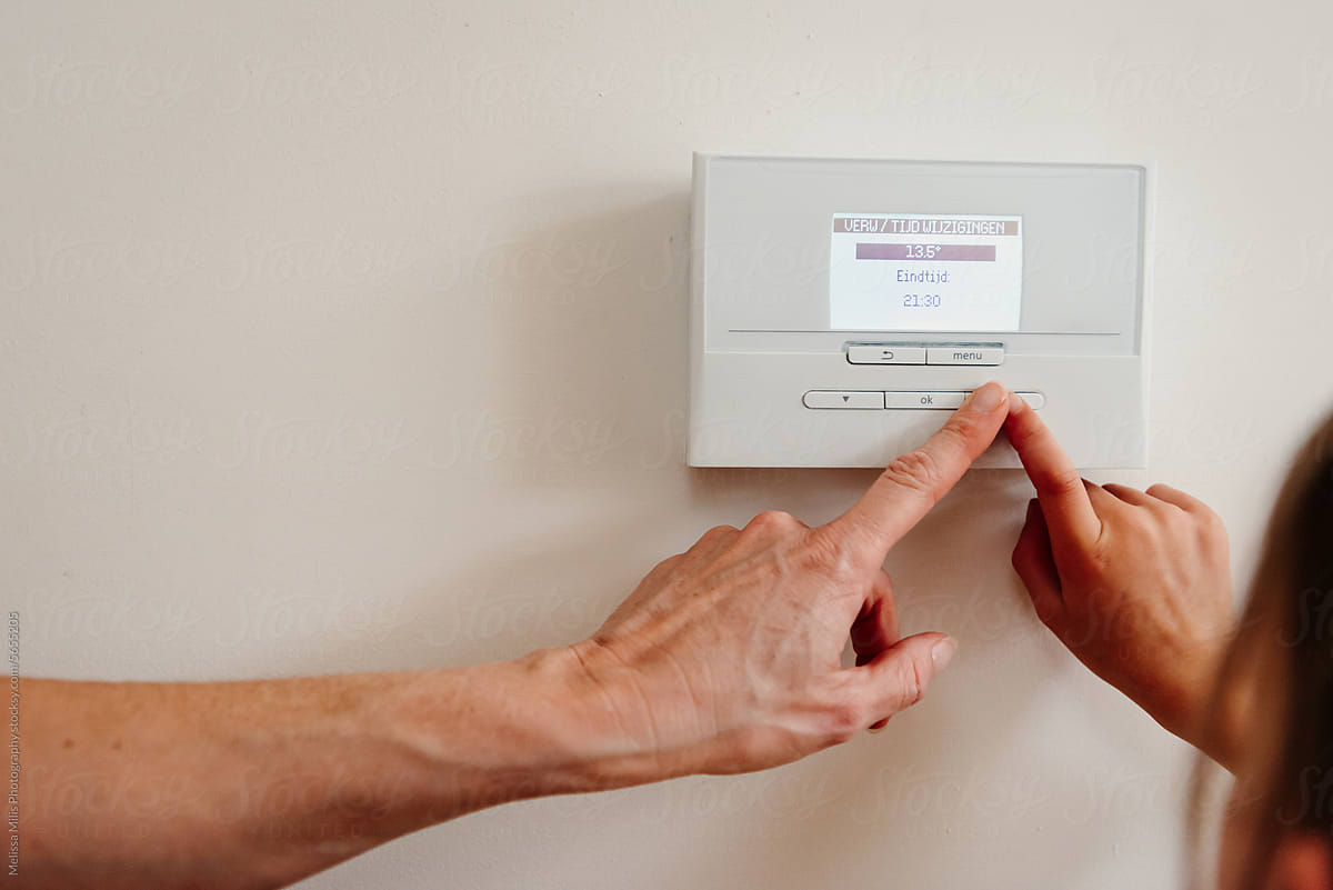 Thermostat being used by mother and daughter