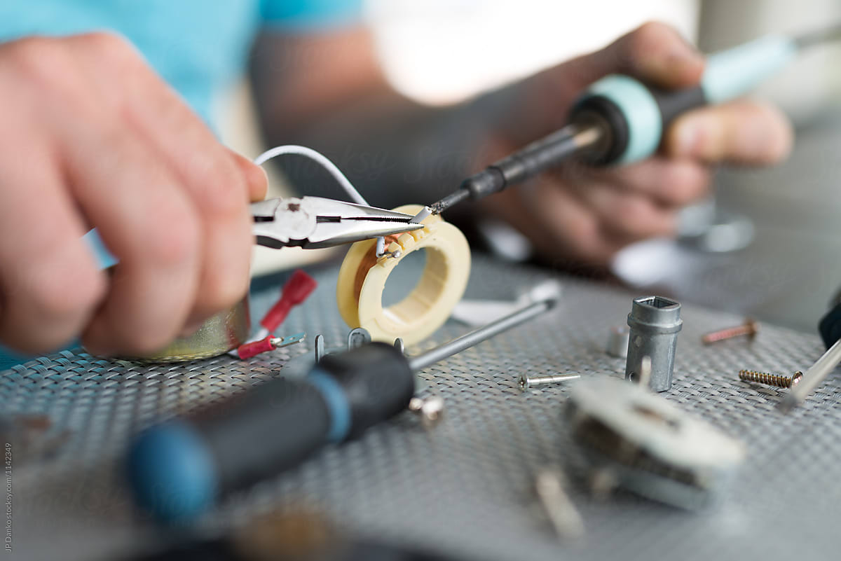 Man Repairing AC Electrical Appliance Motor