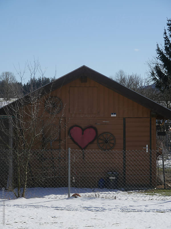 The wooden house with painted hearts on it