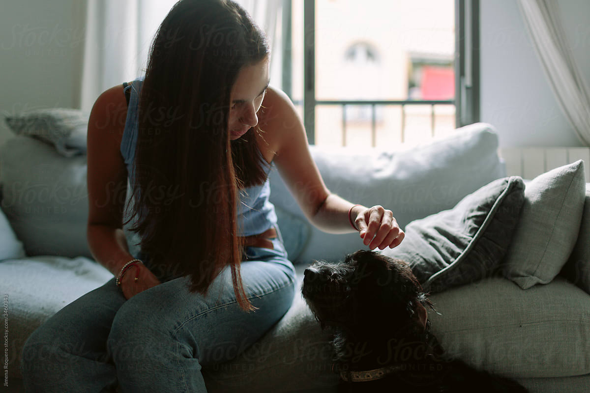 Woman and dog interacting at home