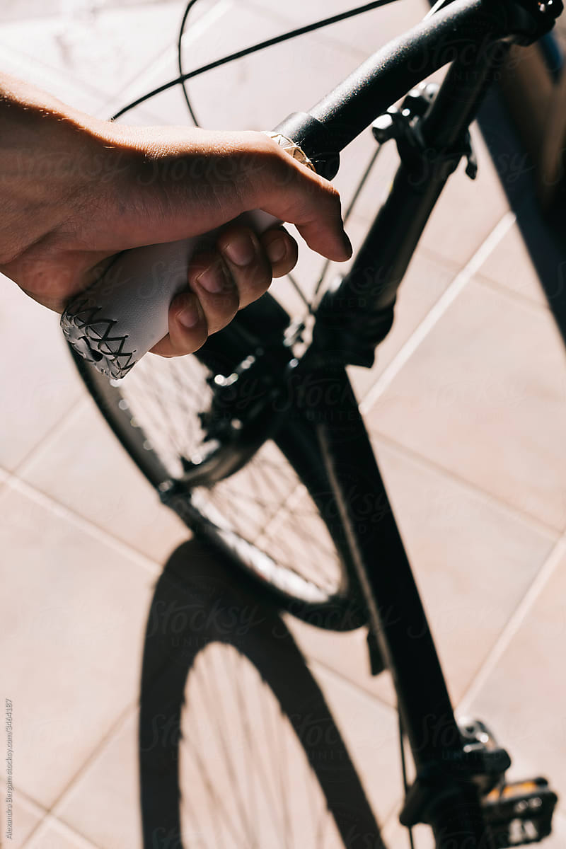 Man hand holds a bicycle handlebar