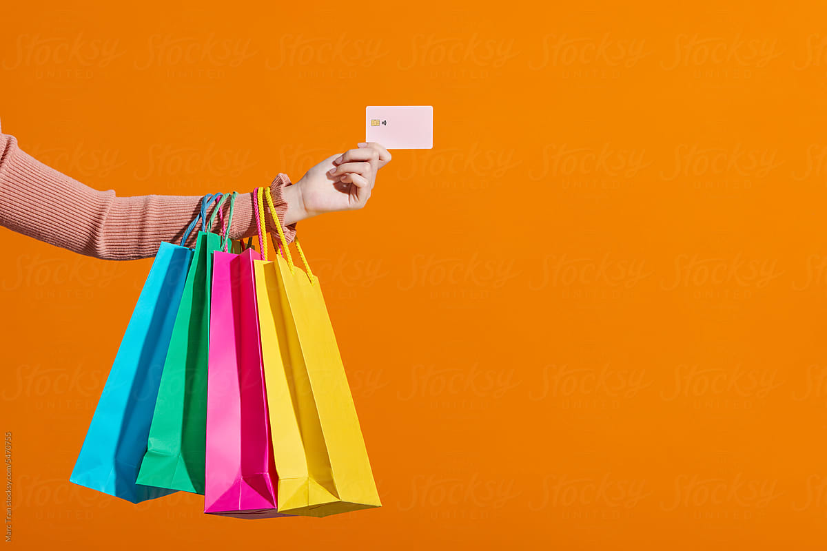 Close up woman hand with many shopping bags and credit card