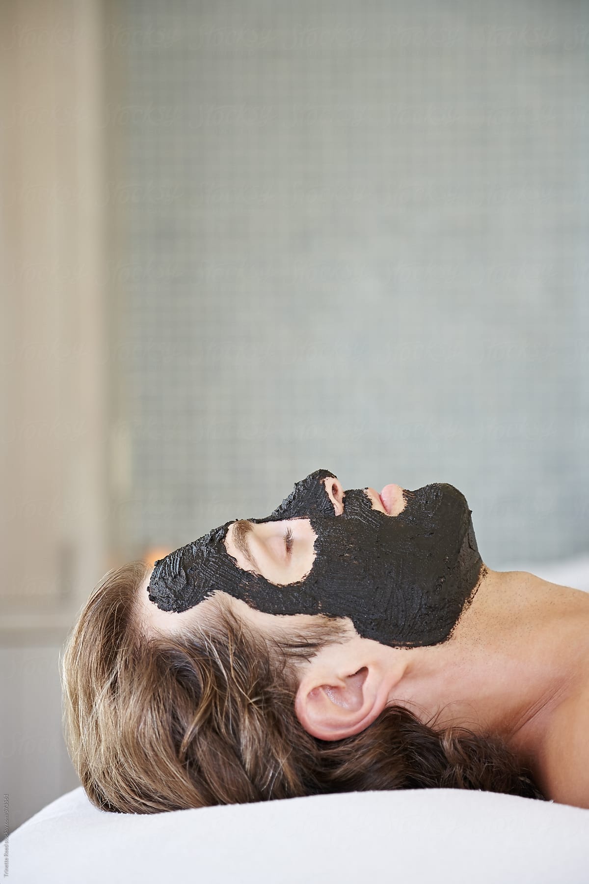 Man receiving a natural mud facial at luxury spa